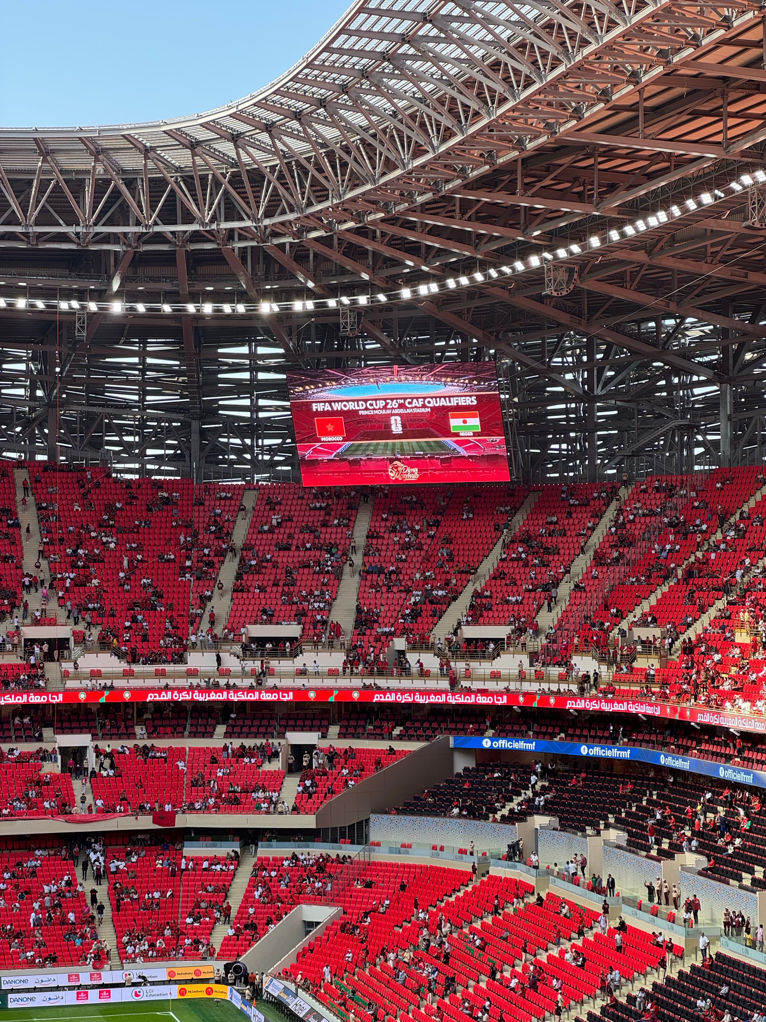 Crowded football stadium with a World Cup qualifier on the big screen